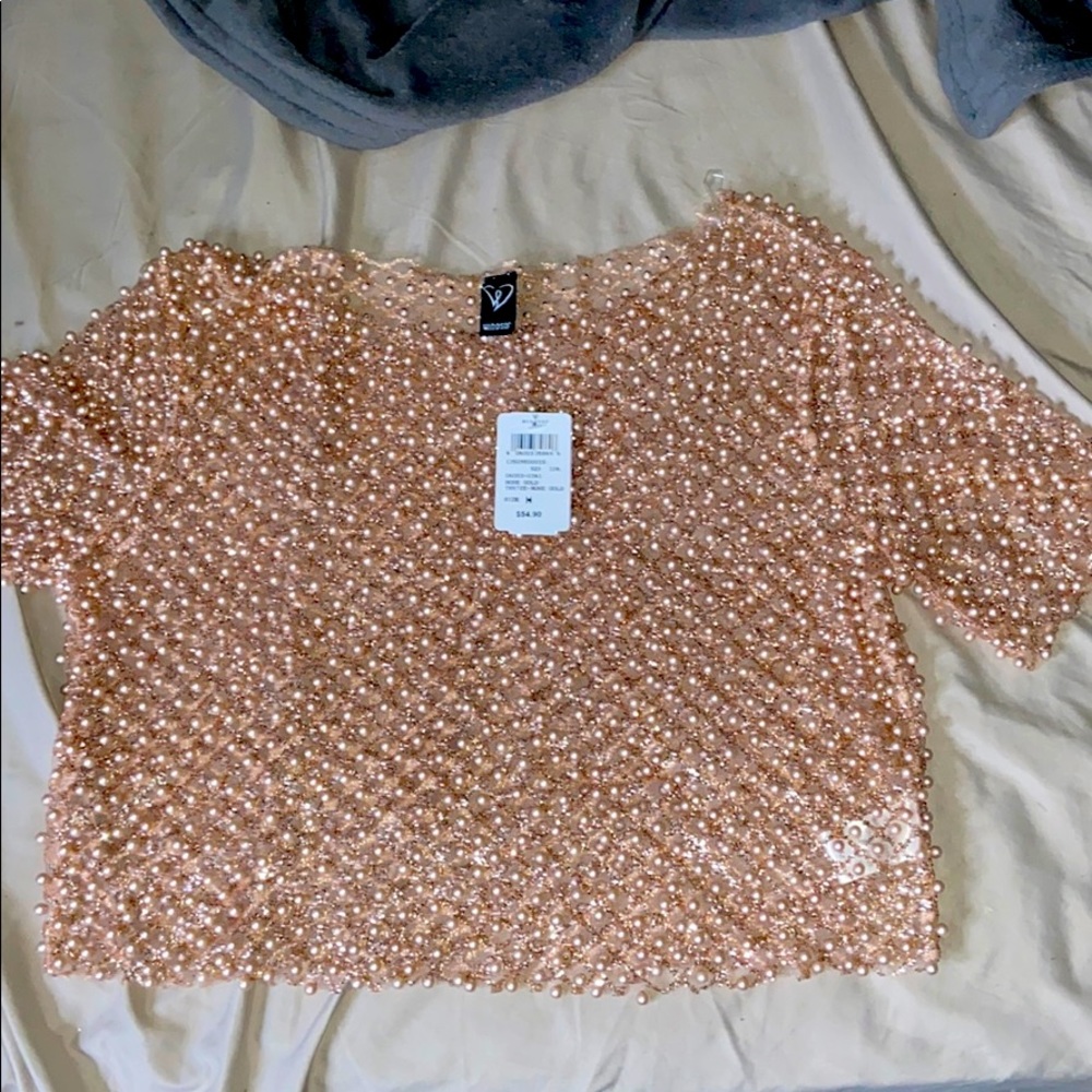 A rose gold beaded top